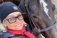Yolanda Hadid smiling next to a horse.